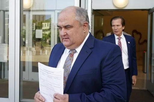 John Davis, former director of the Mississippi Department of Human Services, followed by his attorney Merrida Coxwell, right, leaves the Thad Cochran United States Courthouse in Jackson, Miss., Thursday, Sept. 22, 2022.  Davis pleaded guilty to new federal charges in a conspiracy to misspend tens of millions of dollars that were intended to help needy families in one of the poorest states in the U.S. — part of the largest public corruption case in the state's history.(AP Photo/Rogelio V. Solis