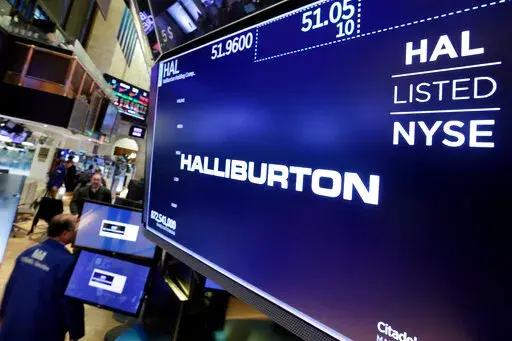 The logo for Halliburton appears above a trading post on the floor of the New York Stock Exchange, Monday, April 23, 2018.  U.S. oil field services companies Halliburton Co. and Schlumberger are suspending their operations in Russia as the Houston, Texas-based businesses react to U.S. sanctions over Russia’s invasion of Ukraine.   (AP Photo/Richard Drew, File)
