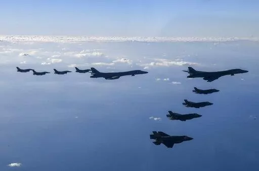 In this photo provided by South Korean Defense Ministry, two U.S. Air Force B-1B bombers, top center, four South Korean Air Force F-35 fighter jets and four US Air Force F-16 fighter jets fly over South Korea Peninsula during a joint air drill called "Vigilant Storm," in South Korea, Saturday, Nov. 5, 2022. North Korea added to its recent barrage of weapons demonstrations by launching four ballistic missiles into the sea on Saturday, as the United States sent two supersonic bombers streaking ove