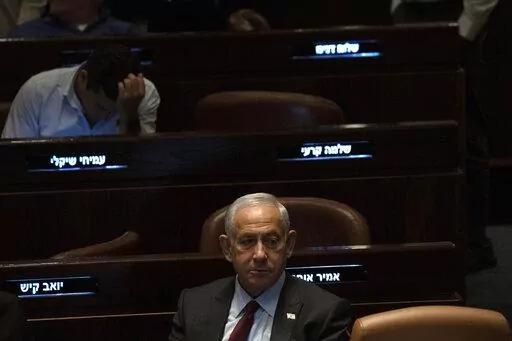 Israeli Prime Minister designate Benjamin Netanyahu, center, pauses during a session after Yariv Levin was selected as Speaker of the Knesset, Israel's parliament, in Jerusalem, Tuesday, Dec. 13, 2022. Over 1,000 senior Israeli air force veterans, including a former Israeli chief of staff, on Monday, Dec. 26, 2022, urged the country’s top legal officials to stand tough against the incoming government, saying the alliance of religious and ultranationalist parties threatens Israel’s future.(AP