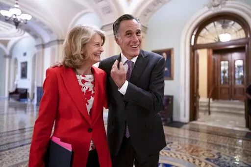 Republican Senators Lisa Murkowski of Alaska, left, and Mitt Romney of Utah, who say they will vote to confirm Judge Ketanji Brown Jackson's historic nomination to the Supreme Court, smile as they greet each other outside the chamber, at the Capitol in Washington, Tuesday, April 5, 2022. Murkowski and Romney join Sen. Susan Collins, R-Maine, who is also bucking the GOP leadership in giving President Joe Biden's nominee a new burst of bipartisan support to become the first Black woman on the high