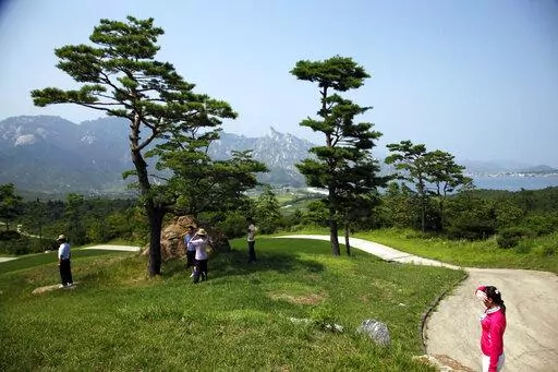 Visitors tour the South Korean-owned golf course at the Mount Kumgang resort, also known as Diamond Mountain, in North Korea on Sept. 1, 2011. North Korea is destroying the golf course in the second confirmed case of South Korean assets being eliminated in an area where the rivals once ran a joint tour program, officials said Tuesday, April 12, 2022, in Seoul. (AP Photo/Ng Han Guan, File)