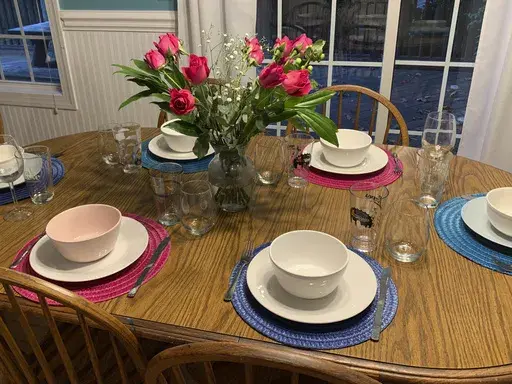 This image provided by Sarah Bellinger shows a table set for a small dinner party with friends on Aug. 25, 2022, in East Hartford, Conn. Bellinger says that throwing her first dinner party was "the most adult thing I did all month." (Sarah Bellinger via AP)wld