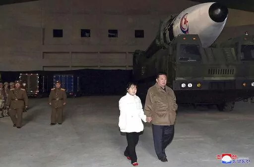 This photo provided on Nov. 19, 2022, by the North Korean government shows North Korean leader Kim Jong Un, right, and his daughter inspecting a missile at Pyongyang International Airport in Pyongyang, North Korea, Friday, Nov. 18, 2022. Independent journalists were not given access to cover the event depicted in this image distributed by the North Korean government. The content of this image is as provided and cannot be independently verified. Korean language watermark on image as provided by s