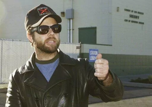 One-time child actor Adam Rich, who starred in the 1970s TV show "Eight is Enough," walks out of a sheriff's station after posting bail in City of Industry, Calif., Dec. 18, 2002. Rich, the child actor with a pageboy mop top who charmed TV audiences as “America's little brother” on “Eight is Enough,” died Saturday, Jan. 7, 2023, in the Brentwood section of Los Angeles. He was 54. The cause of death was under investigation but was not considered suspicious. (AP Photo/Jean-Marc Bouju)