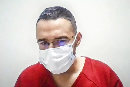 In this image taken from a Zoom screen, Solomon Peña listens as Judge David Murphy orders the defendant to remain behind bars during a court appearance Monday morning. Jan. 23, 2023, in Albuquerque, N.M. Peña, 39, a political newcomer who lost his bid for the New Mexico statehouse and is accused of orchestrating a series of drive-by shootings at the homes of Democratic officials will remain in custody pending trial after the judge agreed Monday that he is a danger to the community. (Roberto E.