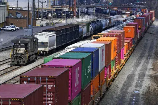 This April 2, 2021, file photo shows freight train cars and containers at Norfolk Southern Railroad's Conway Yard in Conway, Pa. Railroad engineers accepted their deal with the railroads that will deliver 24% raises but conductors rejected the contract casting more doubt on whether the industry will be able to resolve the labor dispute before next month’s deadline without Congress’ help. The votes, Monday, Nov. 21, 2022, by the two biggest railroad unions follows the decision by three other 