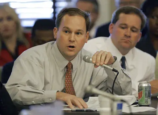 Republican state Rep. Michael Janus of Biloxi, left, shown in this Sept. 27, 2005 file photograph, asks questions at the Mississippi Capitol during a special legislative session weeks after Hurricane Katrina. Janus, who served in the Mississippi House from 1996 to 2009, died Tuesday, Feb. 15, 2022, at age 55. (AP Photo/Rogelio V. Solis, File)