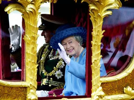 Britain's Queen Elizabeth II accompanied by her husband the Duke of Edinburgh wave to wellwishers as they ride Tuesday, June 4, 2002, in the State Gold Coach from Buckingham Palace to St Paul's Cathedral, in London for a service of thanksgiving to celebrate her Golden Jubilee. Queen Elizabeth II, Britain’s longest-reigning monarch and a rock of stability across much of a turbulent century, has died. She was 96. Buckingham Palace made the announcement in a statement on Thursday Sept. 8, 2022. (