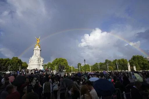 People gather outside Buckingham Palace in London, Thursday, Sept. 8, 2022. Buckingham Palace says Queen Elizabeth II has been placed under medical supervision because doctors are "concerned for Her Majesty's health." Members of the royal family traveled to Scotland to be with the 96-year-old monarch. (AP Photo/Frank Augstein)