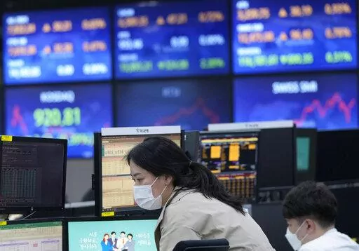 A currency trader watches monitors at the foreign exchange room of the KEB Hana Bank headquarters in Seoul, South Korea, Monday, April 18, 2022. Shares were lower in Asia after China reported Monday that its economy expanded at a 4.8% annual pace in January-March. (AP Photo/Ahn Young-joon)