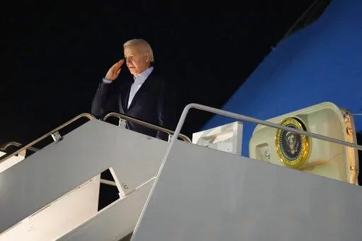 President Joe Biden salutes as he boards Air Force One at Andrews Air Force Base, Md., on Tuesday, Dec. 27, 2022. Biden and his family are traveling to St. Croix, U.S. Virgin Islands, to celebrate New Year. (AP Photo/Manuel Balce Ceneta)