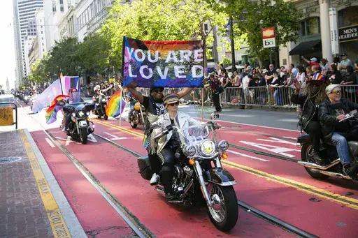 Bikers, center, ride a Harley Davidson motorcycle in the annual Pride Parade in San Francisco June 30, 2024. (Minh Connors/San Francisco Chronicle via AP)