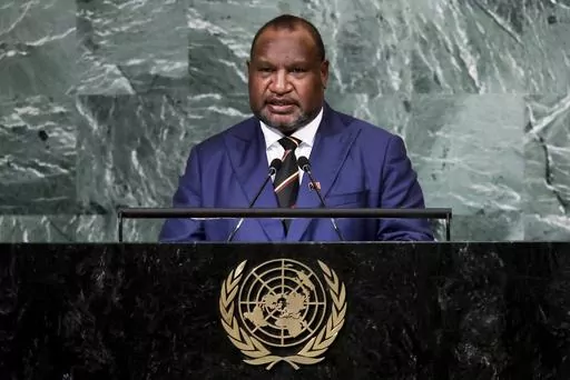 CORRECTS TO DELETE THE DEATH TOLL AS THE NUMBER HAS LOWERED AFTER MORE REPORT - FILE - Prime Minister of Papua New Guinea James Marape addresses the 77th session of the United Nations General Assembly, Sept. 22, 2022, at U.N. headquarters. Multiple people were massacred in a major escalation of tribal violence in Papua New Guinea, Australian media reported Monday, Feb. 19, 2024. Tribal violence in the Enga region has intensified since elections in 2022 that maintained Prime Minister James Marape
