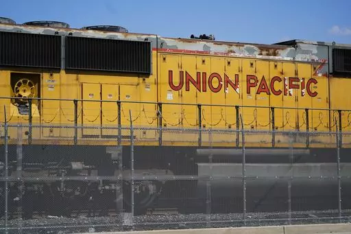 A Union Pacific train engine sits in a rail yard on Wednesday, Sept. 14, 2022, in Commerce, Calif. Union Pacific said Saturday, March 25, 2023, that the company has backed away from the industry's longstanding push to cut train crews down to one person as lawmakers and regulators increasingly focus on rail safety following last month's fiery derailment in Ohio. (AP Photo/Ashley Landis, File)