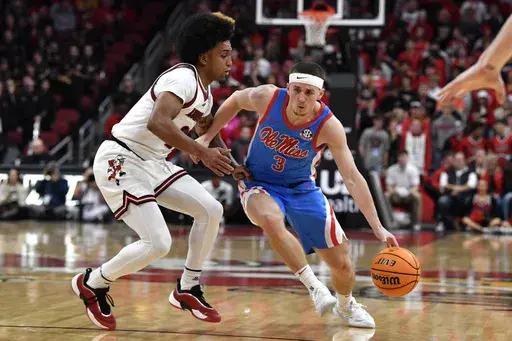 Mississippi guard Sean Pedulla (3) drives on Louisville guard Chucky Hepburn (24) during the first half of an NCAA college basketball game in Louisville, Ky., Tuesday, Dec. 3, 2024. (AP Photo/Timothy D. Easley)