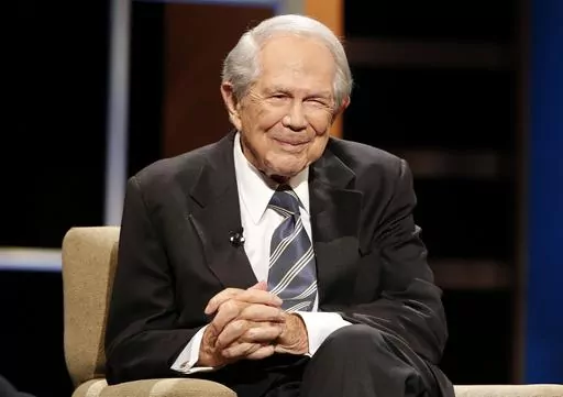 Rev. Pat Robertson poses a question to a Republican presidential candidate during a forum at Regent University in Virginia Beach, Va., Oct. 23, 2015. Robertson, a religious broadcaster who turned a tiny Virginia station into the global Christian Broadcasting Network, tried a run for president and helped make religion central to Republican Party politics in America through his Christian Coalition, has died. He was 93. Robertson's death Thursday, June 8, 2023 was announced by his broadcasting netw