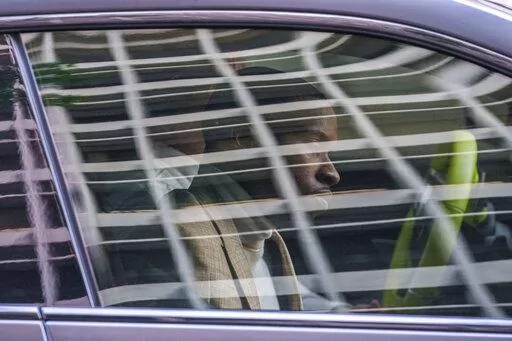 Daystar Peterson, the rap artist known as Tory Lanez, 30, sits in the passenger seat of a sport car as he's driven away from the Clara Shortridge Foltz Criminal Justice Center Tuesday, Dec. 13, 2022, in Los Angeles. Lanez is free on bail after being charged with felony assault for allegedly shooting rapper Megan Thee Stallion in the feet. (AP Photo/Damian Dovarganes)