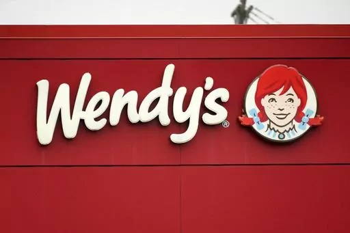 The Wendy's sign is seen at a restaurant, Jan. 23, 2023, in Pittsburgh. Wendy's is looking to test having the prices of its menu items fluctuate throughout the day based on demand, implementing a strategy that has already taken hold with ride-sharing companies and ticket sellers. (AP Photo/Gene J. Puskar, File)