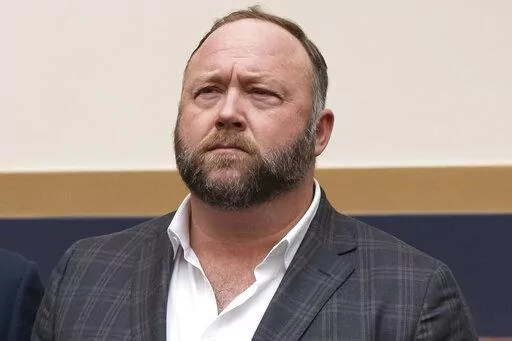 This Tuesday, Dec. 11, 2018, file photo shows radio show host and conspiracy theorist Alex Jones at Capitol Hill in Washington. Infowars host Jones has offered to pay $120,000 per plaintiff to resolve a lawsuit by relatives of Sandy Hook Elementary School shooting victims who said he defamed them by asserting the massacre never happened, according to court filings Tuesday, March 29, 2022. (AP Photo/J. Scott Applewhite, File)