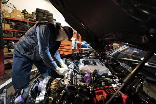 Mechanic David Stoliaruk works on the engine of a car at IC Auto in Philadelphia, May 2, 2023. On Friday, the U.S. government issues its November jobs report. (AP Photo/Matt Rourke, File)