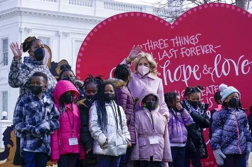 First lady Jill Biden poses for a photo with Aiton Elementary School students and staff as she welcomes school children to the White House in Washington, Monday, Feb. 14, 2022, to celebrate Valentine's Day. (AP Photo/Susan Walsh)
