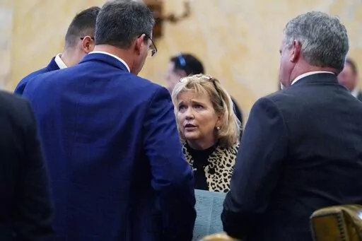Rep. Becky Currie, R-Brookhaven, center, lobbies colleagues to co-sign a bill following adjournment on the first day of the 2023 Legislature at the Mississippi Capitol in Jackson, Tuesday, Jan. 3, 2023. (AP Photo/Rogelio V. Solis)