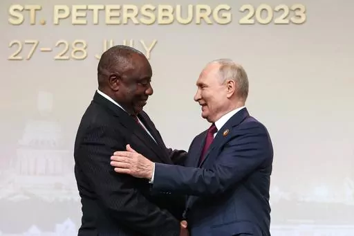 President of the Republic of South Africa Cyril Ramaphosa, left, and Russian President Vladimir Putin shake hands before an official ceremony to welcome the leaders of delegations to the Russia Africa Summit in St. Petersburg, Russia, Thursday, July 27, 2023. Russia and China will look to gain more political and economic ground in the developing world at a summit of the BRICS bloc in South Africa this week. Putin will take part in the main summit on Wednesday, Aug. 23, 2023 via video link after 