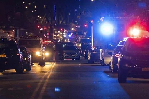 NYPD officers are seen at the scene of shooting in Harlem  on Friday, Jan. 21, 2022, in New York. A New York Police Department officer was killed and another gravely injured Friday night after responding to a domestic disturbance call, according to a law enforcement official.(AP Photo/Yuki Iwamura)