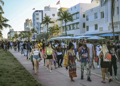 Tourists walk alongside Ocean Drive in Miami Beach, Fla., on March 21, 2021. A water main break in Miami Beach caused pressure to drop and forced officials to issue a boil water alert for the tourism hotspot on Friday, July 21, 2023. (Carl Juste/Miami Herald via AP, File)