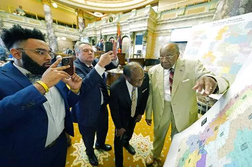 Mississippi state Sens. Rod Hickman, D-Macon, left, Michael McLendon, R-Hernando, second from left, Albert Butler, D-Port Gibson, and David Jordan, D-Greenwood, review an alternate Senate redistricting map during debate on the floor of the Senate at the Mississippi state Capitol in Jackson, Miss., March 29, 2022. The Mississippi NAACP filed a lawsuit Tuesday, Dec. 20, challenging the state House and Senate redistricting plans adopted by lawmakers in 2022 for use beginning in 2023 elections. The 