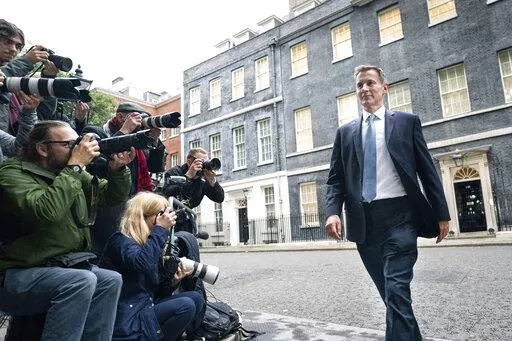 Jeremy Hunt leaves 10 Downing Street in London after he was appointed Chancellor of the Exchequer following the resignation of Kwasi Kwarteng, Friday Oct. 14, 2022. Chancellor of the Exchequer Kwasi Kwarteng said he has accepted Prime Minister Liz Truss' request he "stand aside" as Chancellor, paying the price for the chaos unleashed by his mini-budget. (Stefan Rousseau/PA via AP)