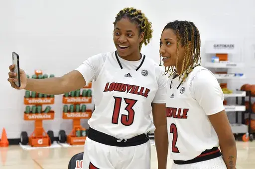 Louisville forward Melissa Russell (13) interviews guard Ahlana Smith (2) during the team's NCAA college basketball media day in Louisville, Ky., Oct. 26, 2021. (AP Photo/Timothy D. Easley, File)