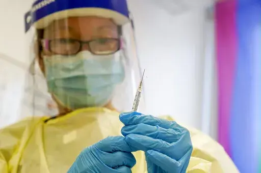 A physician assistant prepares a syringe with the monkeypox vaccine for a patient during a vaccination clinic Friday, Aug. 19, 2022, in New York. The disease’s spread is slowing but the virus is unlikely to be eliminated because it is widespread enough that spread of the disease is expected to continue, the Centers for Disease Control and Prevention said in late September 2022. (AP Photo/Mary Altaffer, File)