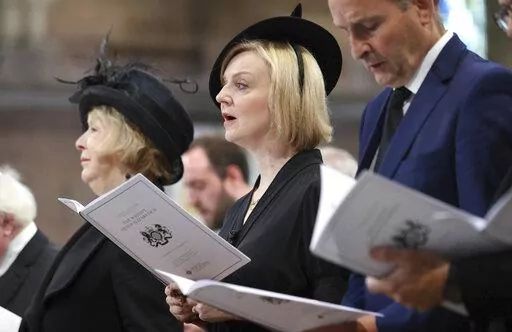 Britain's Prime Minister Liz Truss attends a memorial service for Britain's Queen Elizabeth II at St Anne's Cathedral in Belfast, Tuesday Sept. 13, 2022. British Prime Minister Liz Truss took office less than two weeks ago, impatient to set her stamp on government. The death of Queen Elizabeth II ripped up Truss’s carefully laid plans for the first weeks of her term, putting everyday politics in the U.K. on hold as the country was plunged into official and emotional mourning. (Liam McBurney/Po