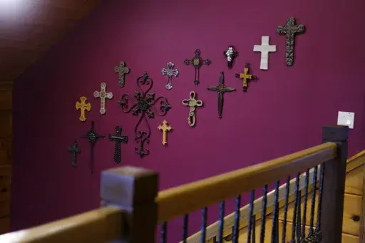 Crosses hang from one of the walls at the Rev. Ron Blakely’s home near Watertown, Tenn., on Friday, July 26, 2024. (AP Photo/Luis Andres Henao)