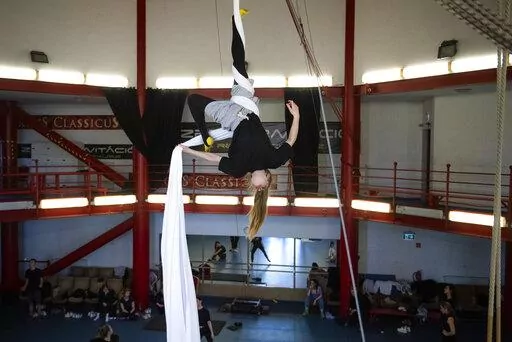 A Ukrainian circus artist who fled the war in Ukraine trains in a circus practice facility in Budapest, Hungary, Tuesday, March 22, 2022. Around 100 Ukrainian circus art students aged 5-20, with their adult chaperones, escaped the embattled cities of Kharkiv and Kyiv amid Russian bombings. In neighboring Hungary, fellow circus devotees extended help and solidarity, taking them in and allowing them to continue training in the safety of the capital, Budapest. (AP Photo/Anna Szilagyi)