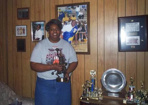 Lusia Harris Stewart shows off some of her medals and awards from her basketball career, Jan. 10, 2002, in her home in Greenwood, Miss. Harris, who was the only woman to be drafted by an NBA team and scored the first points in women's basketball history at the Olympics, died Tuesday, Jan. 18, 2022, her family announced. She was 66. (Tony Krausz/The Delta Democrat-Times via AP, File)