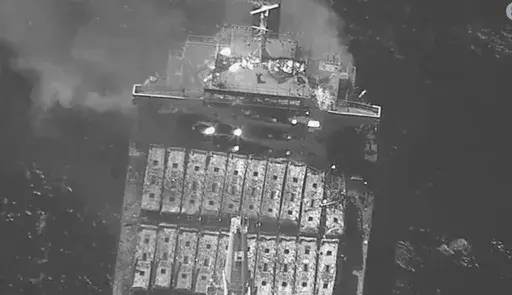 This black-and-white image released by the U.S. military's Central Command shows the fire aboard the bulk carrier True Confidence after a missile attack by Yemen's Houthi rebels in the Gulf of Aden on Wednesday, March 6, 2024. A missile attack by Yemen's Houthi rebels on a commercial ship in the Gulf of Aden on Wednesday killed three of its crew members and forced survivors to abandon the vessel, the U.S. military said. It was the first fatal strike in a campaign of assaults by the Iranian-backe