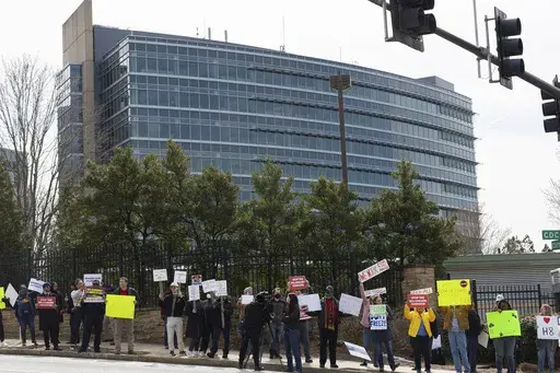 Demonstrators protest Centers for Disease Control and Prevention (CDC) layoffs in front of the CDC headquarters in Atlanta, Feb. 18, 2025. (Arvin Temkar/Atlanta Journal-Constitution via AP, file)