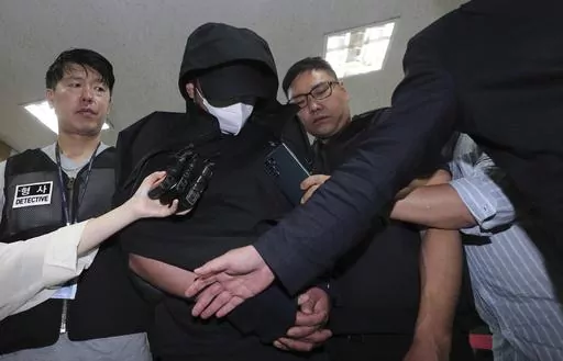 A man who opened an emergency exit door during a flight, arrives to attend an arrest warrant review at the Daegu District Court in Daegu, South Korea, Sunday, May 28, 2023. He told police that he felt suffocated and tried to get off the plane quickly as it approached landing, reports said Saturday. (Yun Kwan-shick/Yonhap via AP)