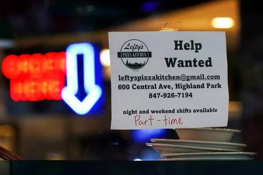 Hiring sign is displayed at a restaurant in Highland Park, Ill., Thursday, July 14, 2022.  The nation's job market last month delivered just what the Federal Reserve and nervous investors had hoped for: A Goldilocks-style hiring report. Job growth was solid — not too hot, not too cold. And more Americans began looking for work, which could ease worker shortages over time and defuse some of the inflationary pressures that the Fed has made its No. 1 mission. (AP Photo/Nam Y. Huh)