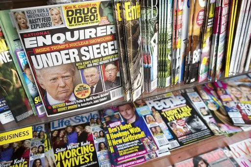 In this July 12, 2017 file photo, an issue of the National Enquirer featuring President Donald Trump on its cover is displayed on a newsstand in a store in New York. VVIP Ventures is buying the U.S. and U.K editions of the National Enquirer, the tabloid that engaged in “catch-and-kill” practices to bury stories about Donald Trump during his presidential campaign. Financial terms were not disclosed. (AP Photo/Mary Altaffer, File)