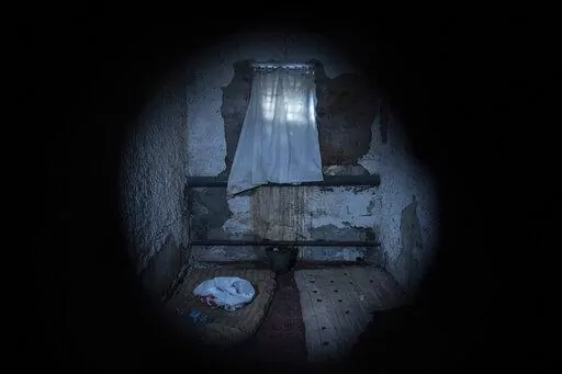 Mattresses lie on the floor in a holding cell at the basement of a police station which was used by Russian forces in the recently liberated town of Izium, Ukraine, Thursday, Sept. 22, 2022. Based on accounts of survivors and police, Associated Press journalists located 10 torture sites in the town and gained access to five of them including the police station. (AP Photo/Evgeniy Maloletka)