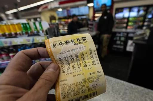A Powerball lottery ticket is seen inside a convenience store, Monday, April 1, 2024, in Kennesaw, Ga. Powerball will match a record for lottery losing Saturday night, April 6, with a stretch of more than three months without a jackpot winner. (AP Photo/Mike Stewart, FIle)