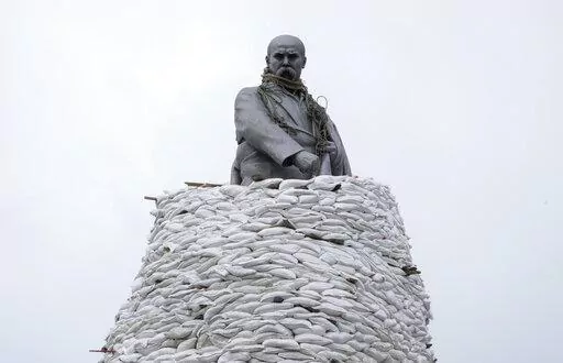 A monument of Taras Shevchenko, a Ukrainian poet and a national symbol, is covered with bags to protect it from Russian shelling in Kharkiv, Ukraine, Sunday, March 27, 2022. The bronze, 16-meter high monument was placed in 1935, survived WWII and is considered one of the world's best monuments to Shevchenko. (AP Photo/Efrem Lukatsky)