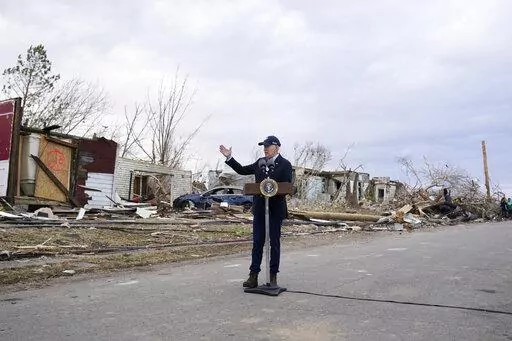 President Joe Biden speaks after surveying storm damage from tornadoes and extreme weather in Dawson Springs, Ky., Dec. 15, 2021. Biden faces a steep path to achieve his ambitious goal of slashing planet-warming greenhouse gas emissions in half by 2030. His $2 trillion Build Back Better plan contains $550 billion in spending and tax credits aimed at promoting clean energy.  (AP Photo/Andrew Harnik, File)