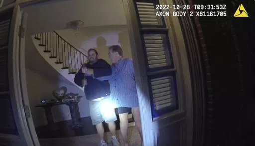 In this image taken from San Francisco Police Department body-camera video, the husband of former U.S. House Speaker Nancy Pelosi, Paul Pelosi, right, fights for control of a hammer with his assailant David DePape during a brutal attack in the couple's San Francisco home, on Oct. 28, 2022. DePape convicted of attempting to kidnap then-House Speaker Nancy Pelosi and attacking her husband with a hammer is set to be sentenced in federal court Friday, May 17, 2024. (San Francisco Police Department v