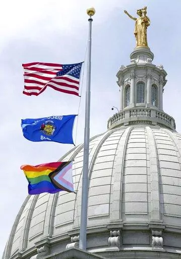 In this Wednesday, June 1, 2022, photo, a Rainbow Pride flag is raised at the Capitol in Madison, Wis. A Wisconsin school board has voted in favor of a policy that prohibits teachers and staff from displaying gay pride flags and other items that district officials consider political in nature. (Mark Hoffman/Milwaukee Journal-Sentinel via AP, File)