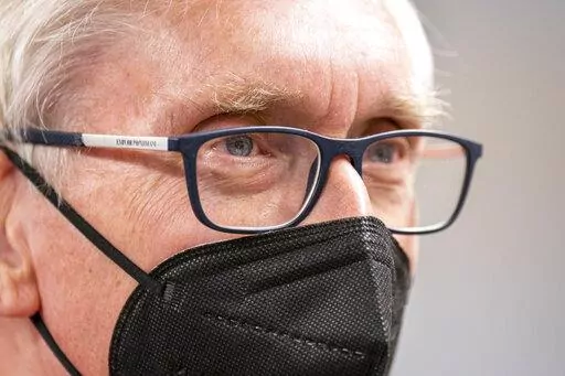 Wisconsin Gov. Tony Evers listens during a gathering of about 50 Democrats at a party headquarters Saturday, Jan. 8, 2022, in Janesville, Wis. The 70-year-old grandfather and former teacher is trying to convince voters that he's also a valiant defender of democracy and the lone figure ensuring their votes will still matter in 2024 and beyond. (AP Photo/Andy Manis)